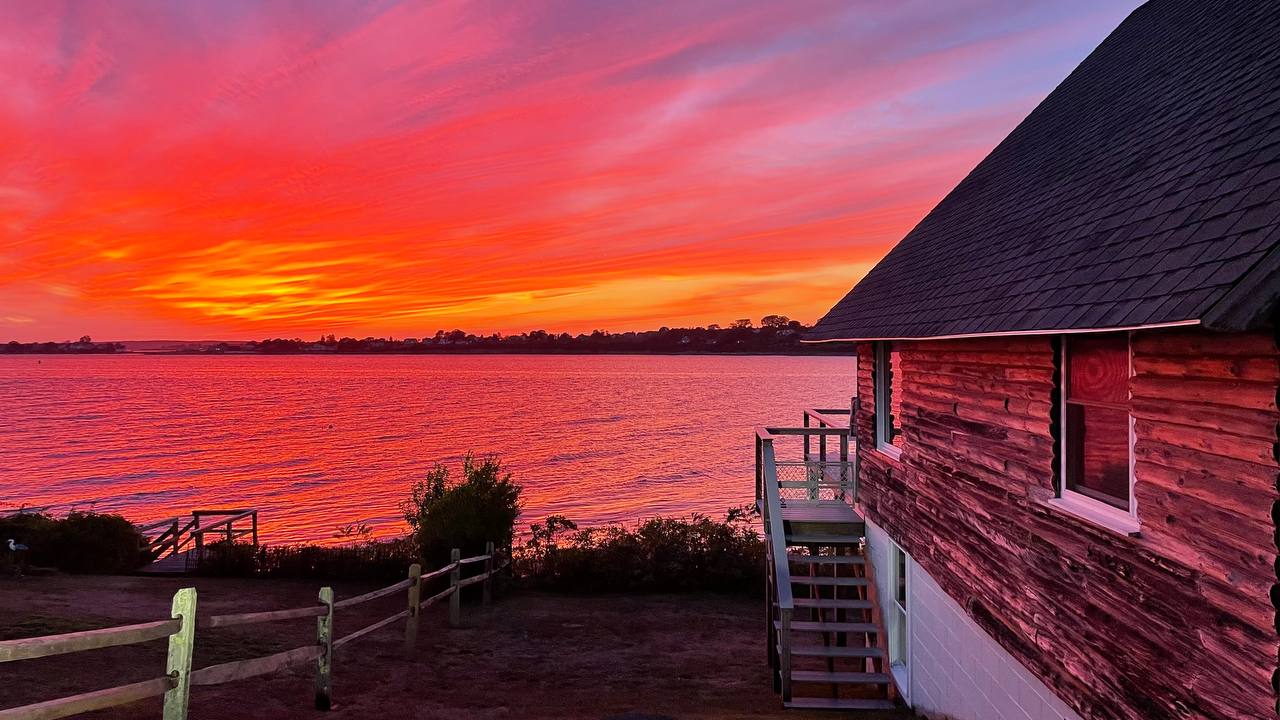Dramatic red and pink sunset with cottage